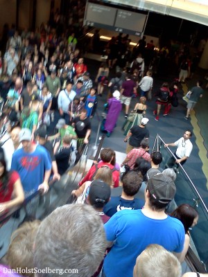 Crowds on the escalator ride down to the convention floor.